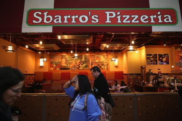 WASHINGTON, DC - MARCH 10: Commuters pass by the Union Station location of pizza restaurant chain Sbarro March 10, 2014 in Washington, DC. Sbarro filed for bankruptcy protection today, the company's second since filing in 2011. (Photo by Alex Wong/Getty Images)