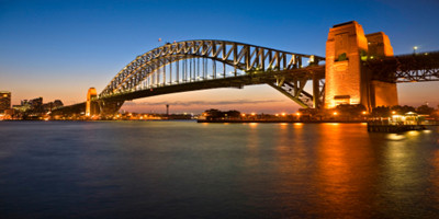 Classic shot of Sydney Harbour Bridge, illuminated at twilight.